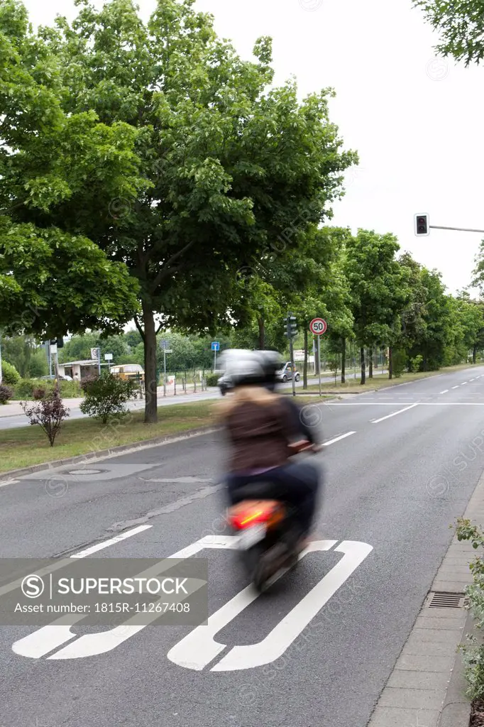 Germany, Hesse, Moped speeding in street