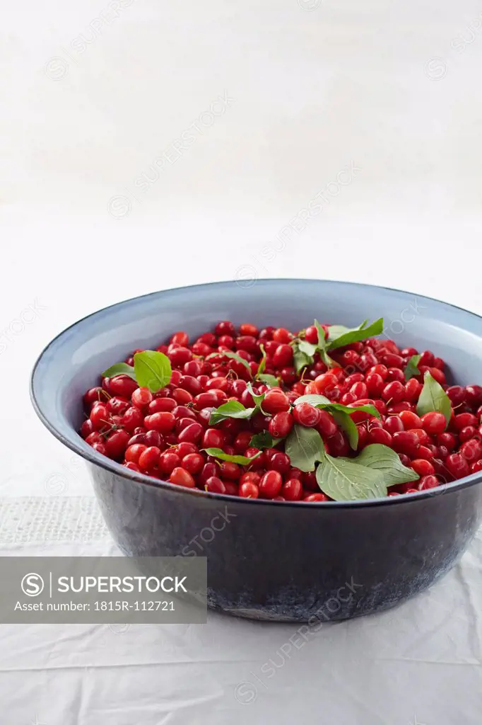 Bowl full of cornel cherries on table