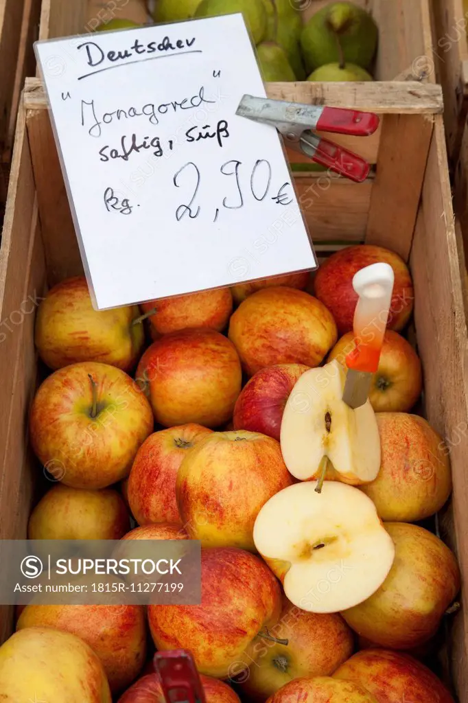 Wooden box of apples on market