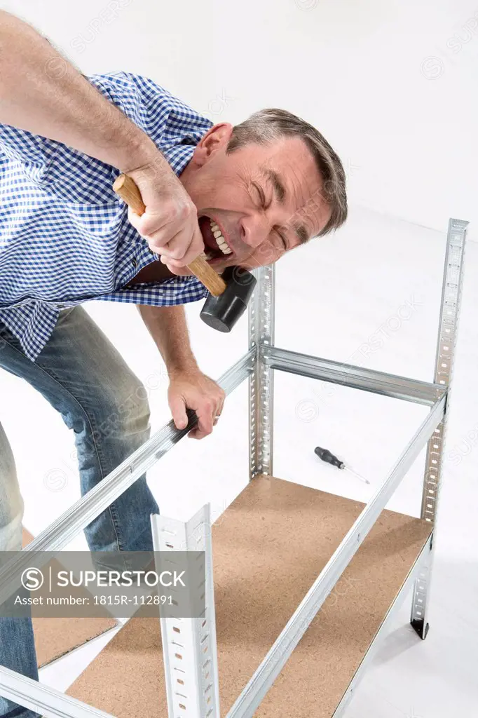Mature man building shelf