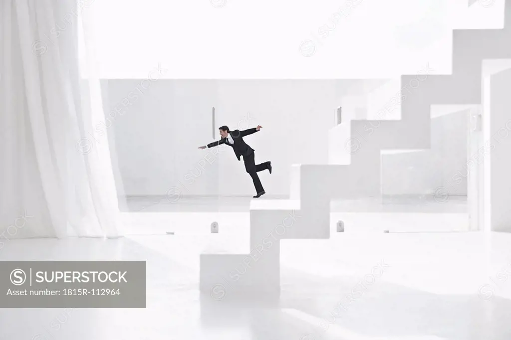 Spain, Businessman falling down from ladders