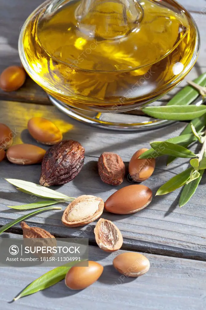 Argan nuts, Argania spinosa, leaves and Argan oil bottle