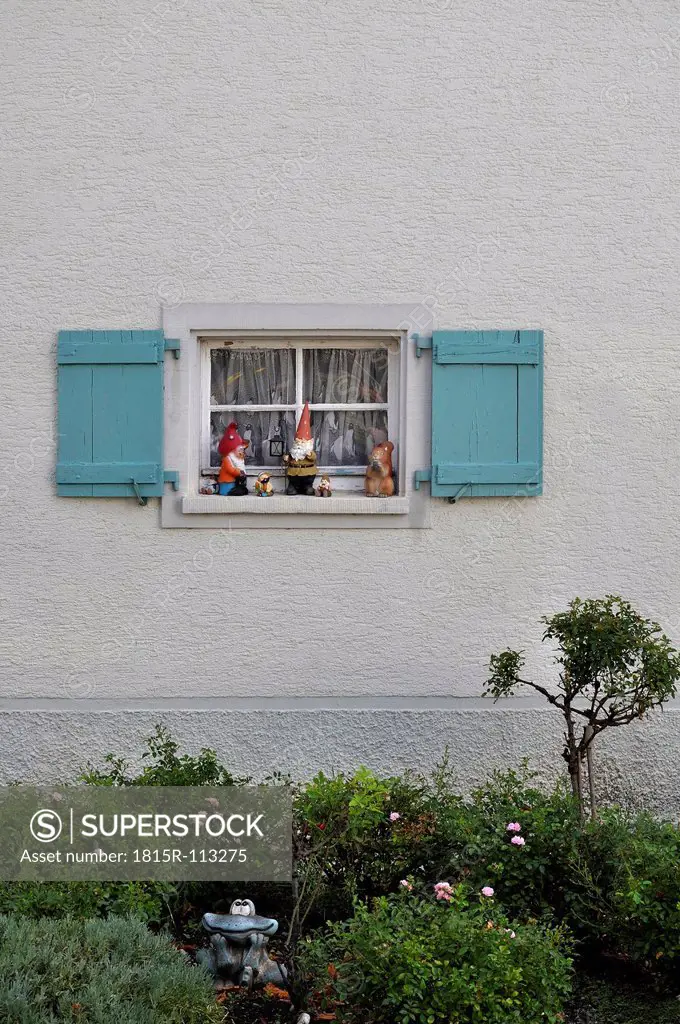 Germany, Baden Wuerttemberg, Window with shutter and garden gnomes