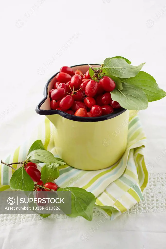 Cornel cherries in pot on table