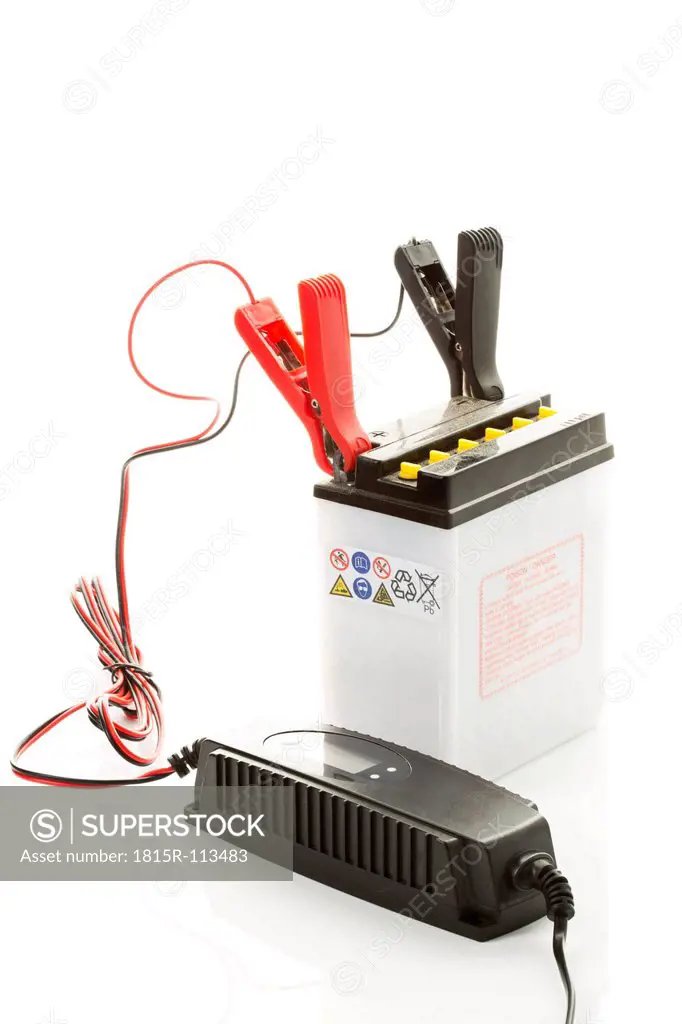 Car battery with charger on white background