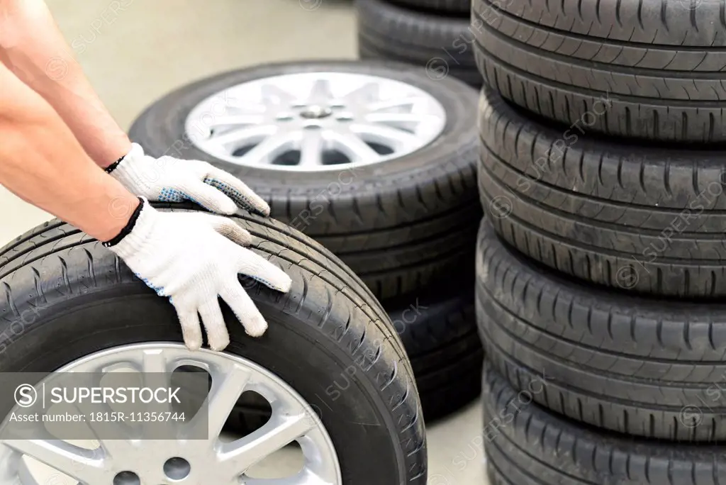 Close-up of car mechanic with tires