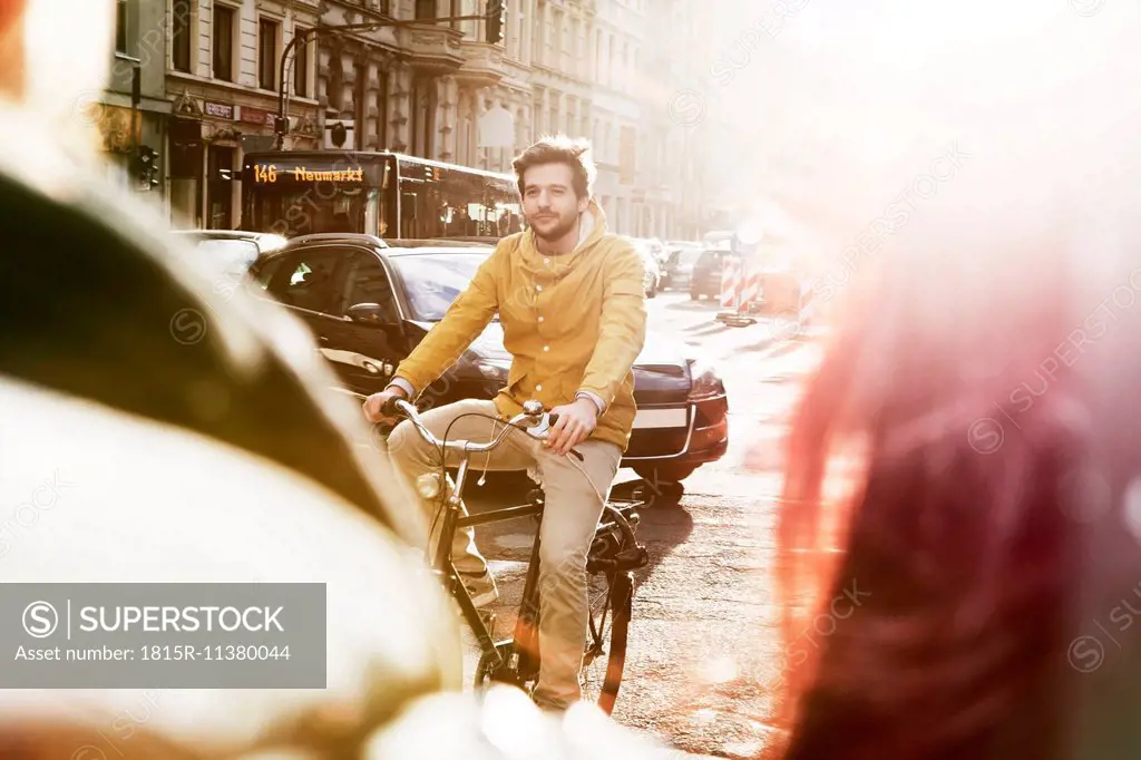 Germany, North Rhine-Westphalia, Cologne, young man riding bicycle