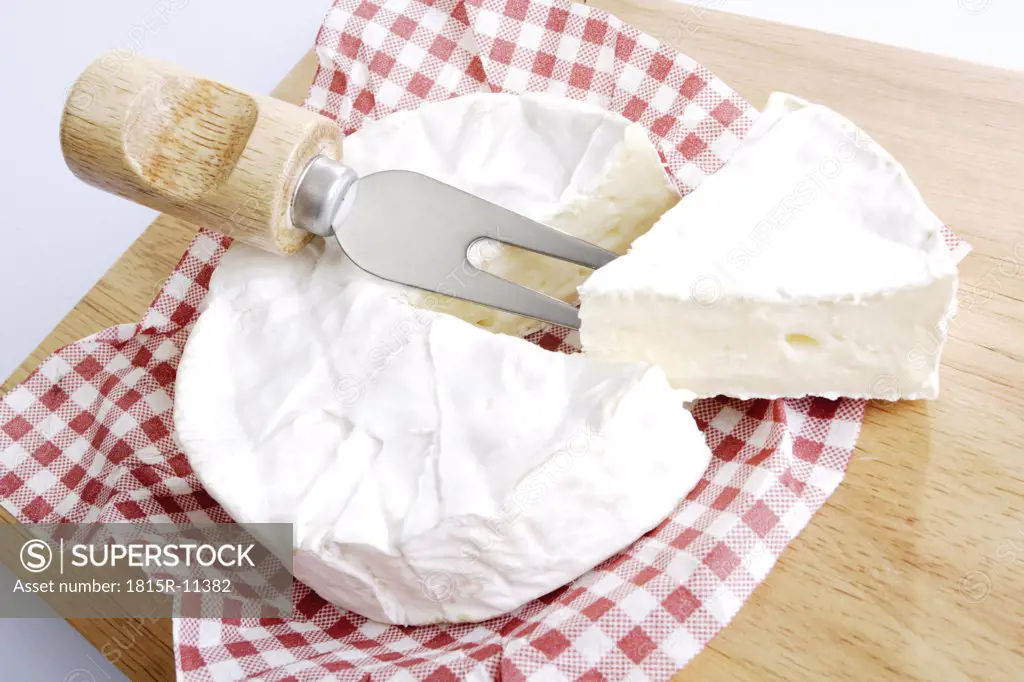 Fresh camembert on chopping board, elevated view