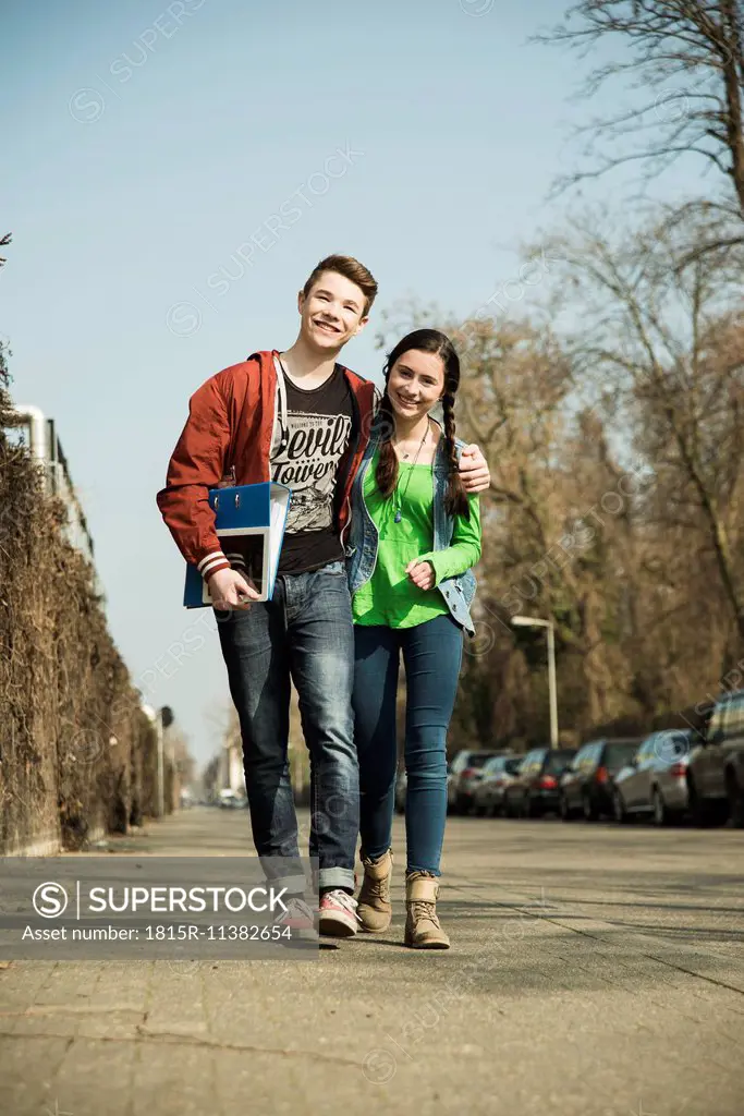 Teenage couple walking side by side