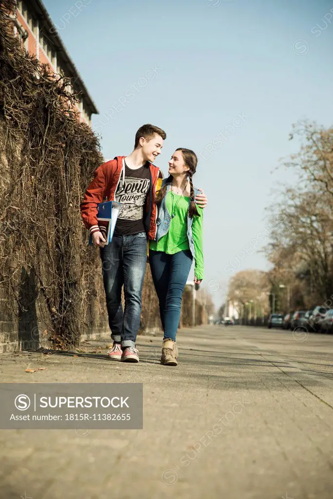 Teenage couple walking side by side