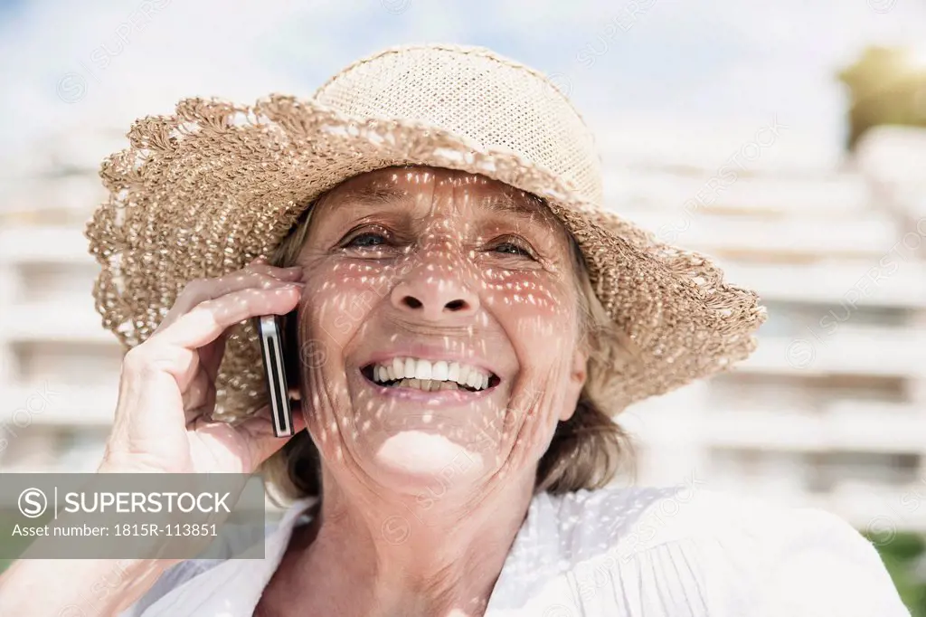Spain, Senior woman talking on mobile phone