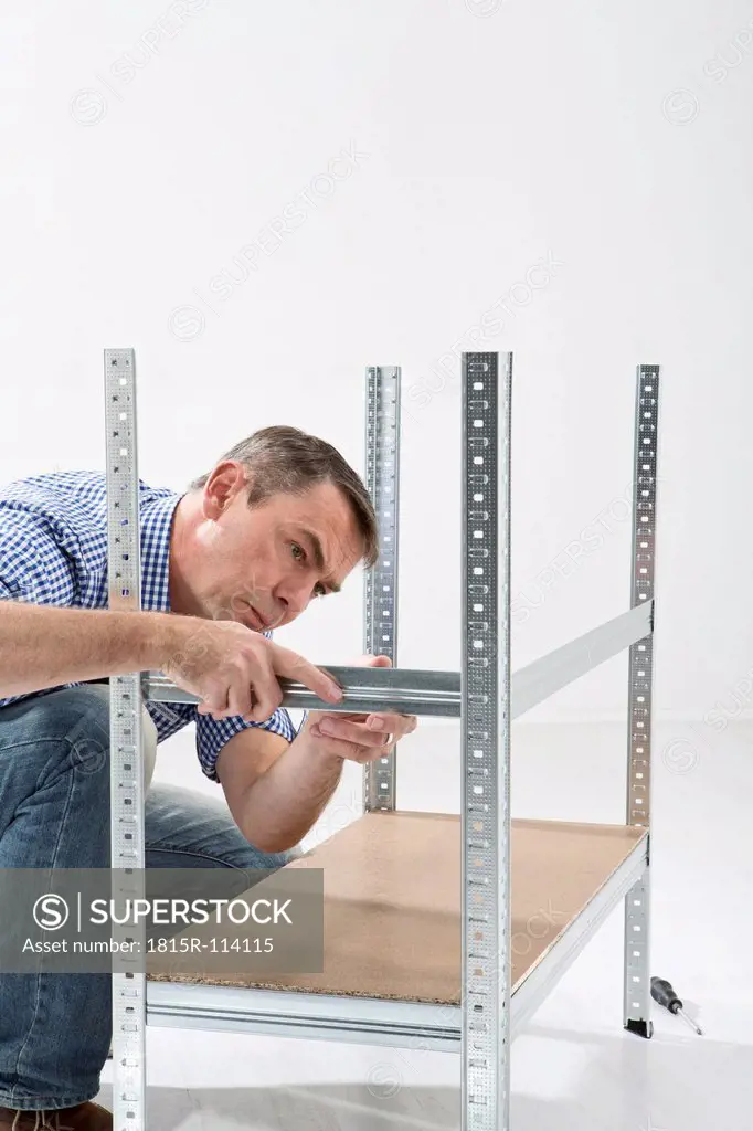 Mature man building shelf