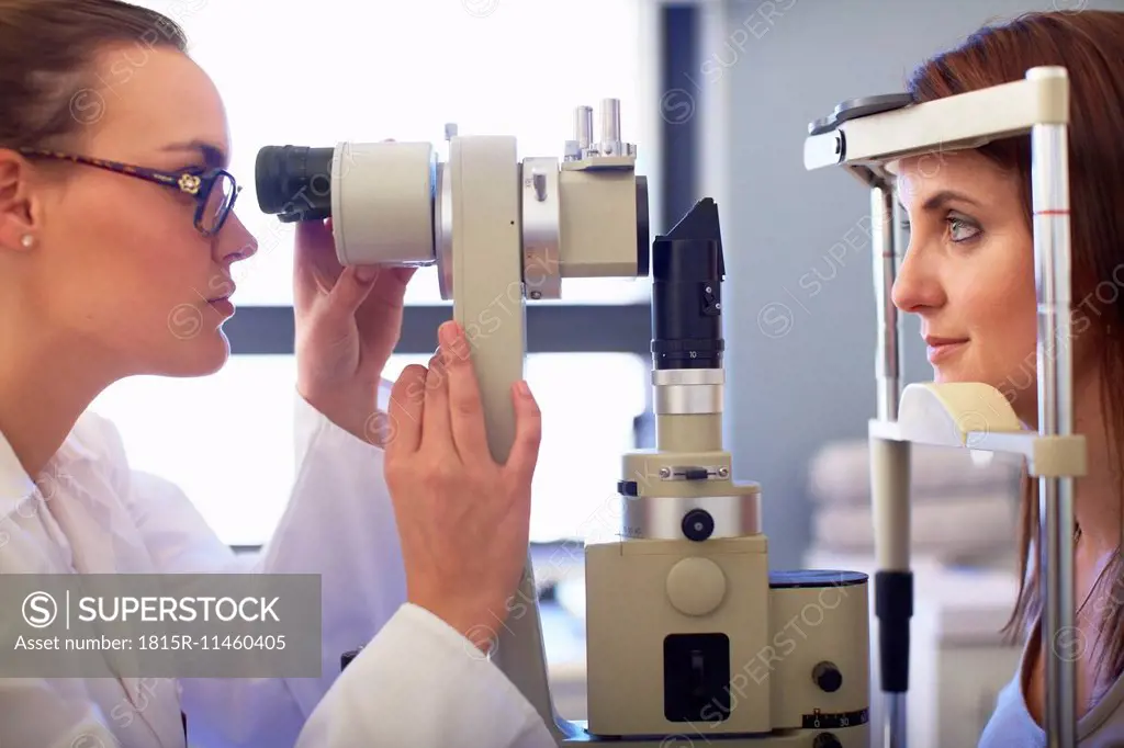 Eye doctor examining woman's vision