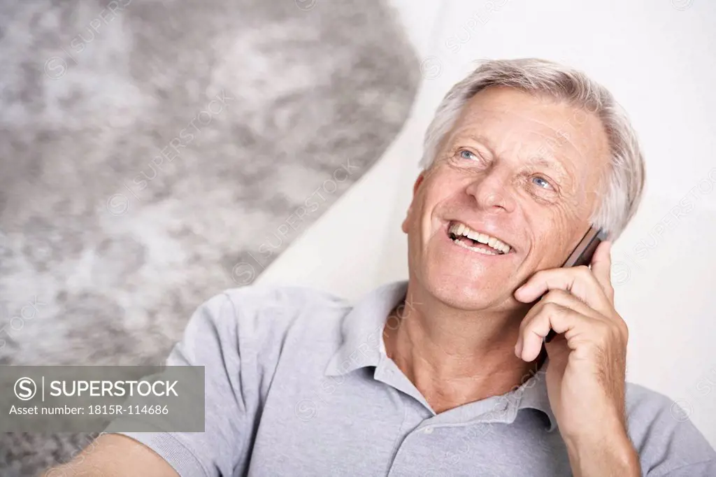 Spain, Senior man talking on mobile, smiling
