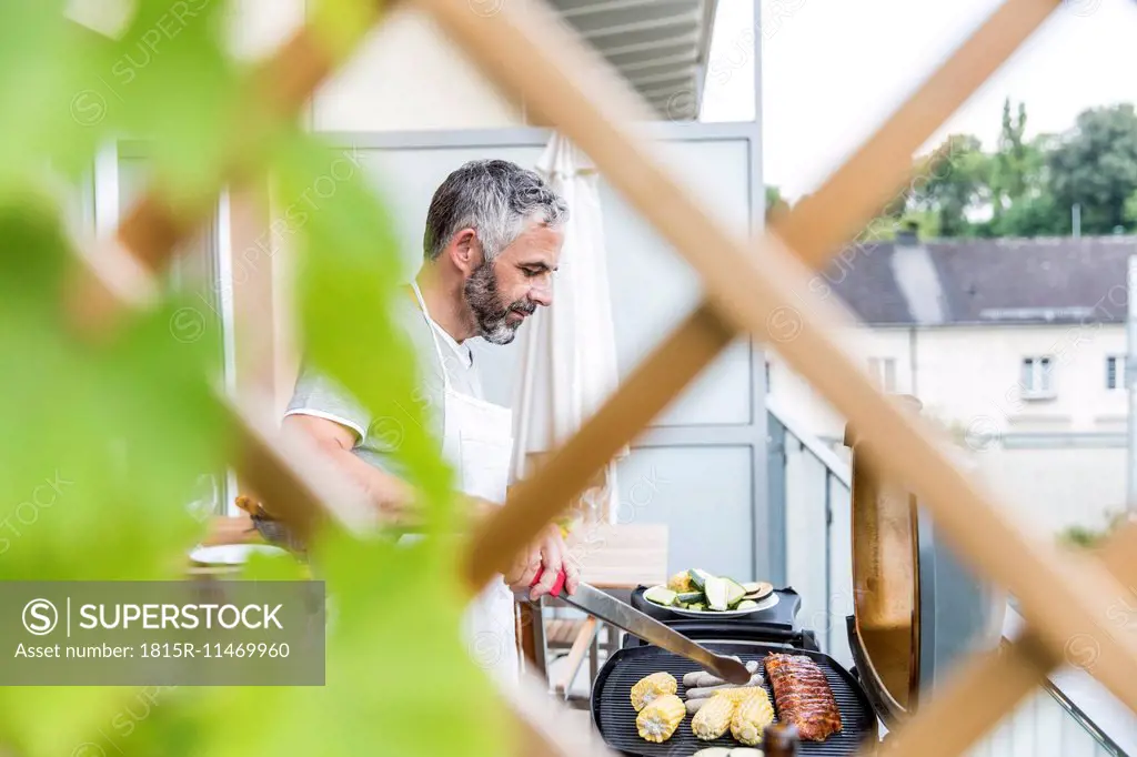 Man barbecuing on his balcony