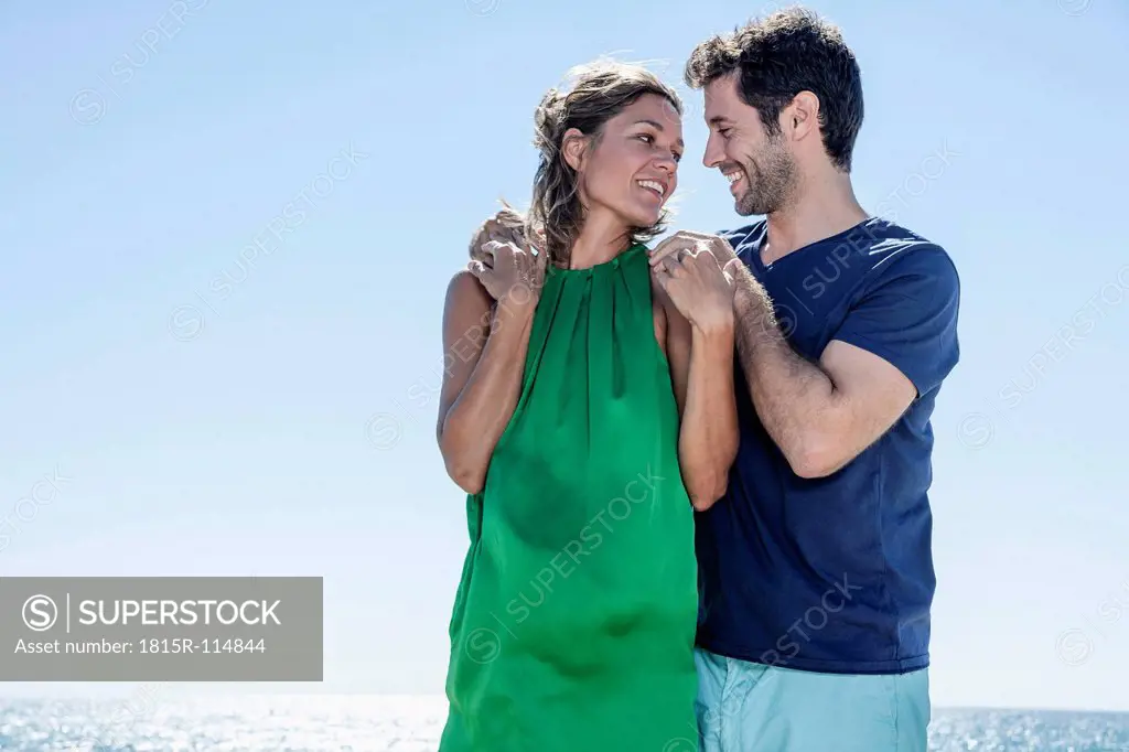 Spain, Mid adult couple looking at each other, smiling