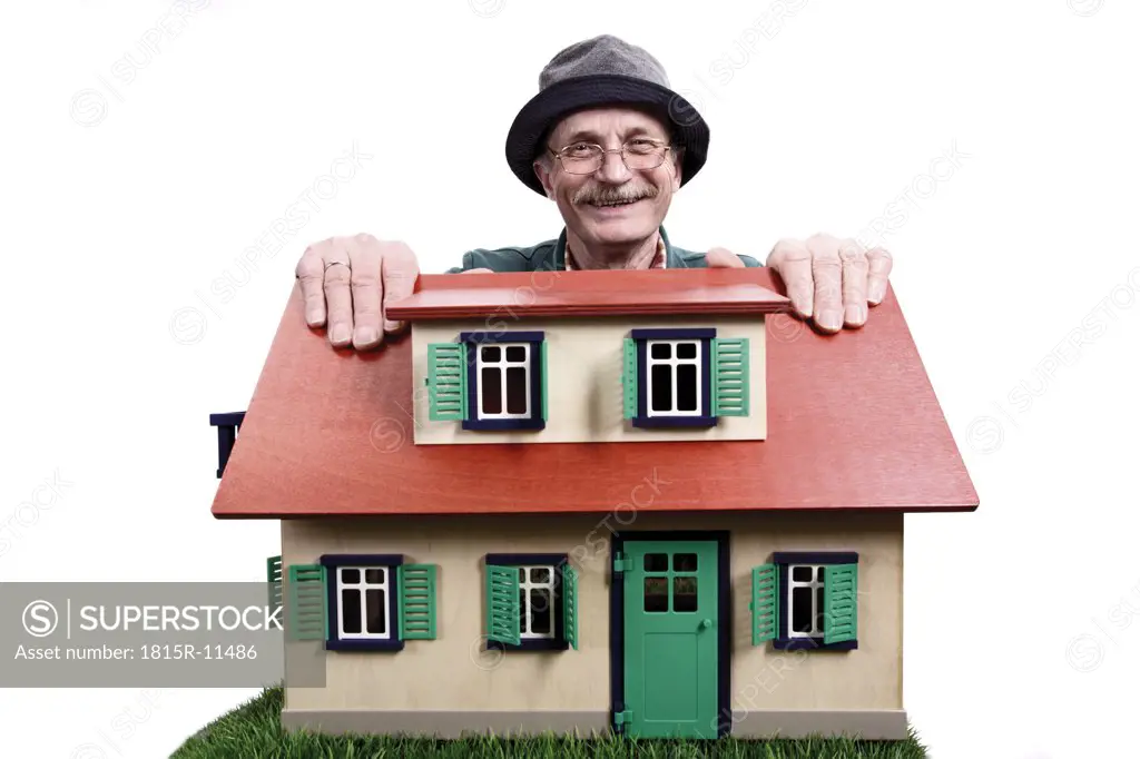 Old man with house, proud home owner