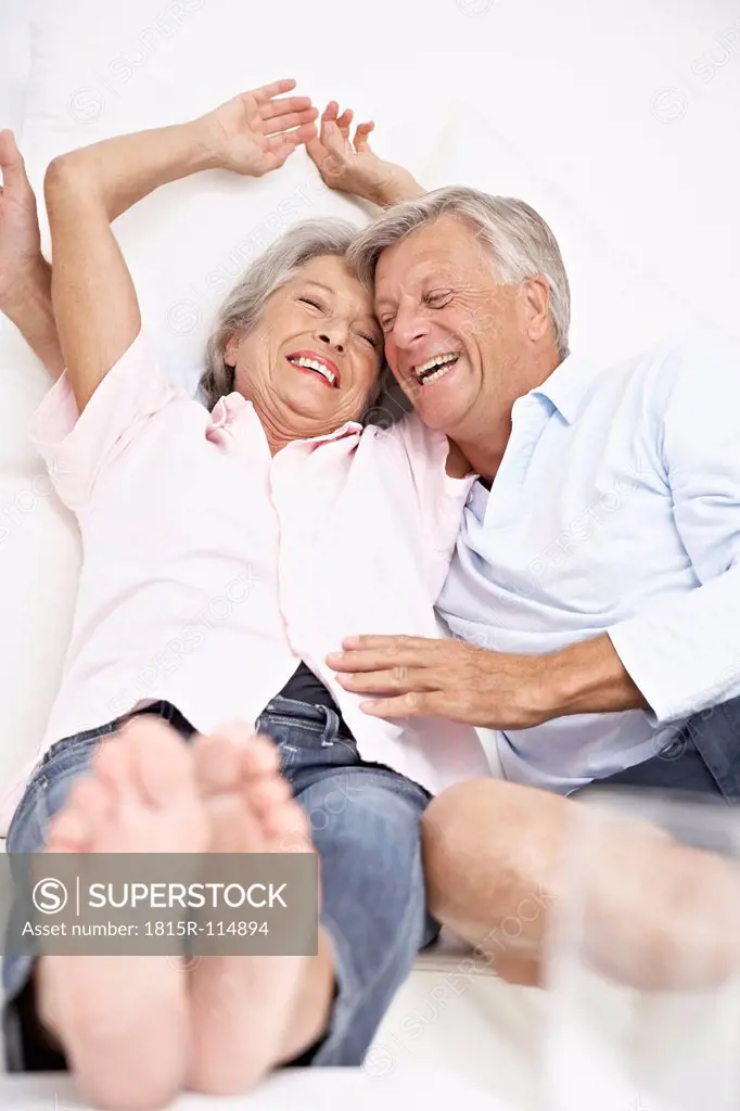 Spain, Senior couple waking up, smiling