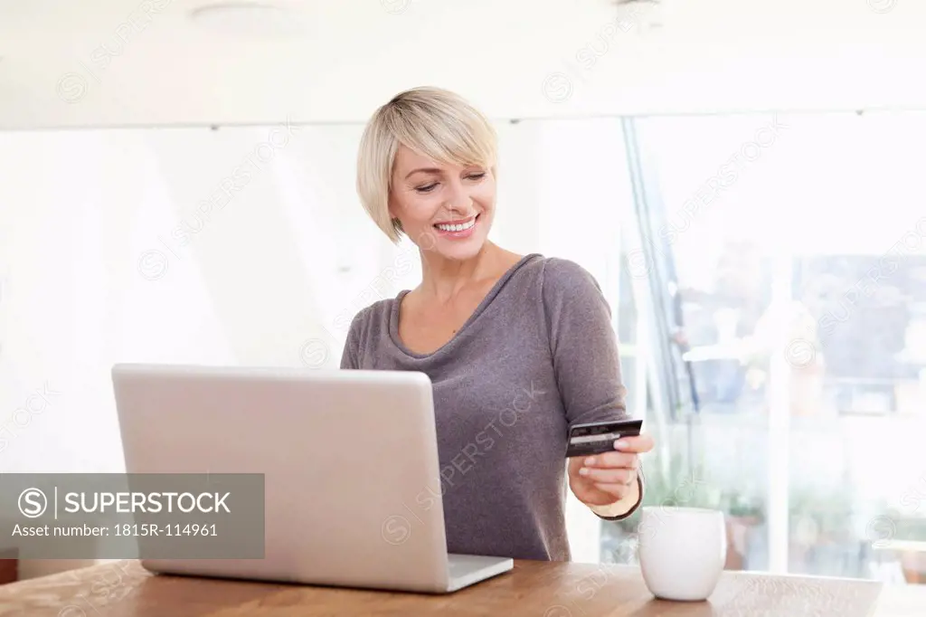 Germany, Bavaria, Munich, Woman shopping with credit card on laptop