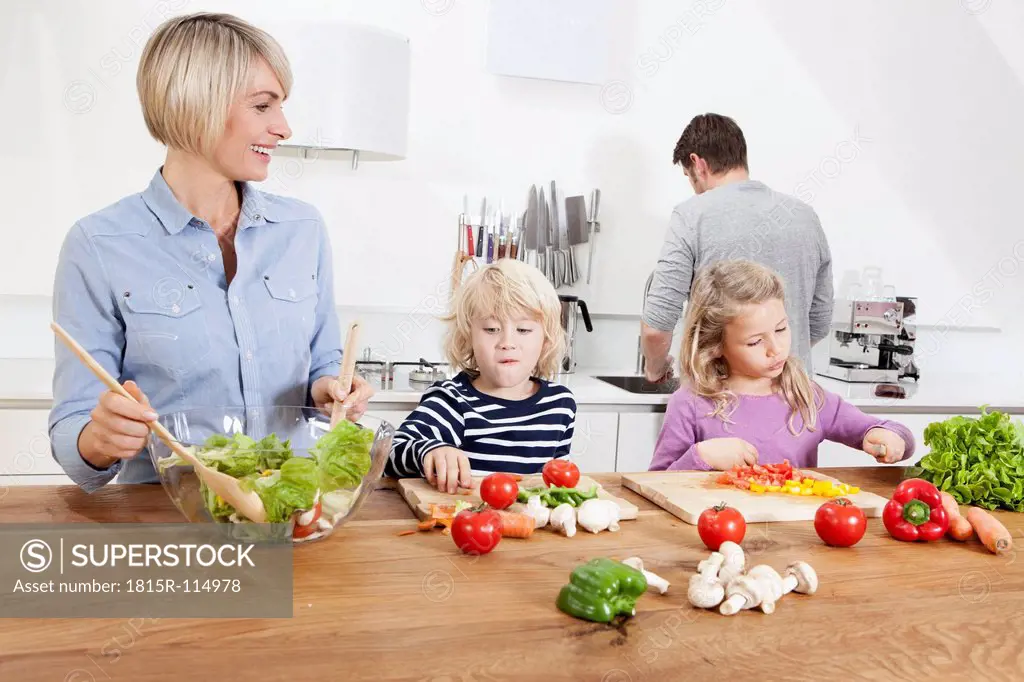 Germany, Bavaria, Munich, Family preparing food in kitchen