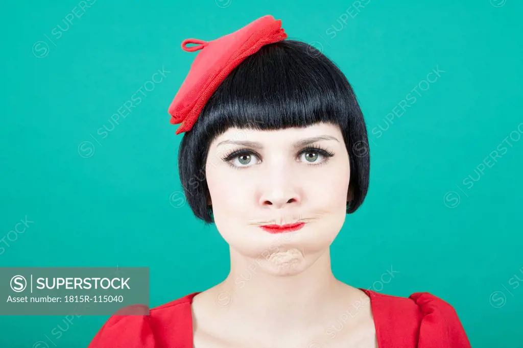 Close up of young woman against green background
