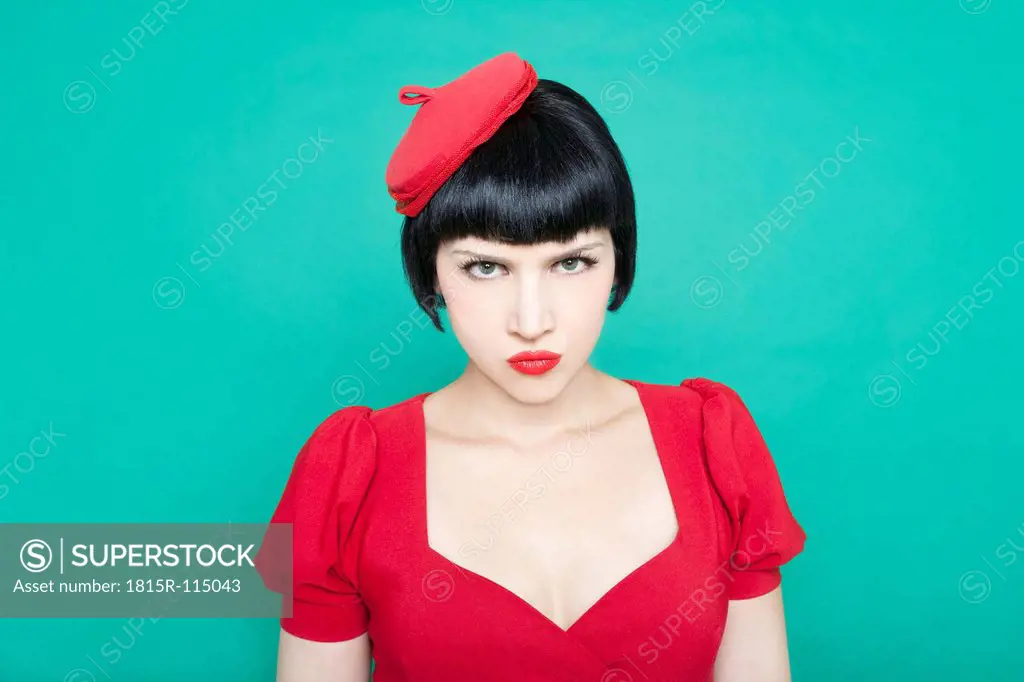 Close up of young woman against green background