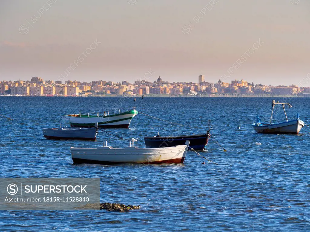 Italy, Sicily, Province of Trapani, Fishing boats and Marsala in the background