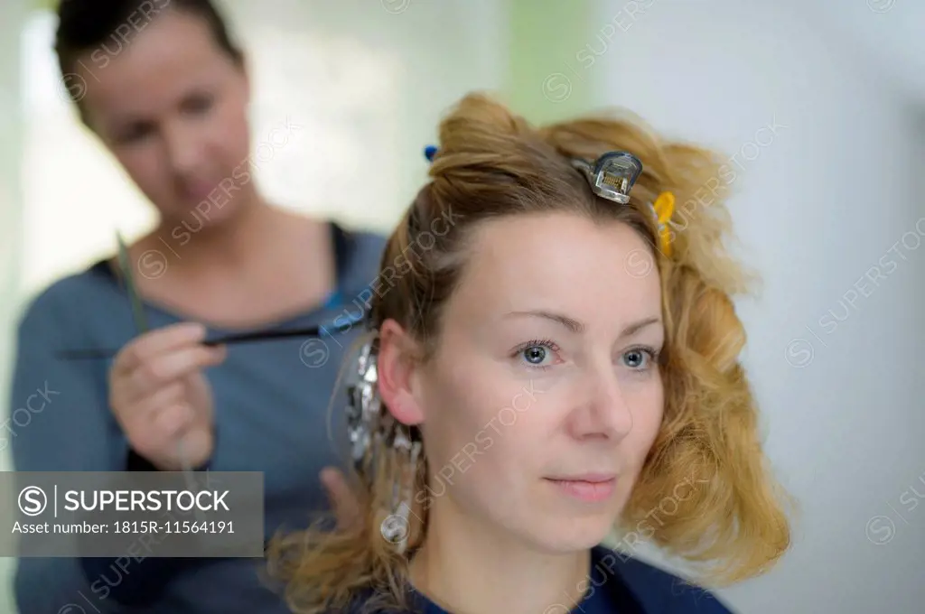Portrait of woman getting highlights at hairdresser