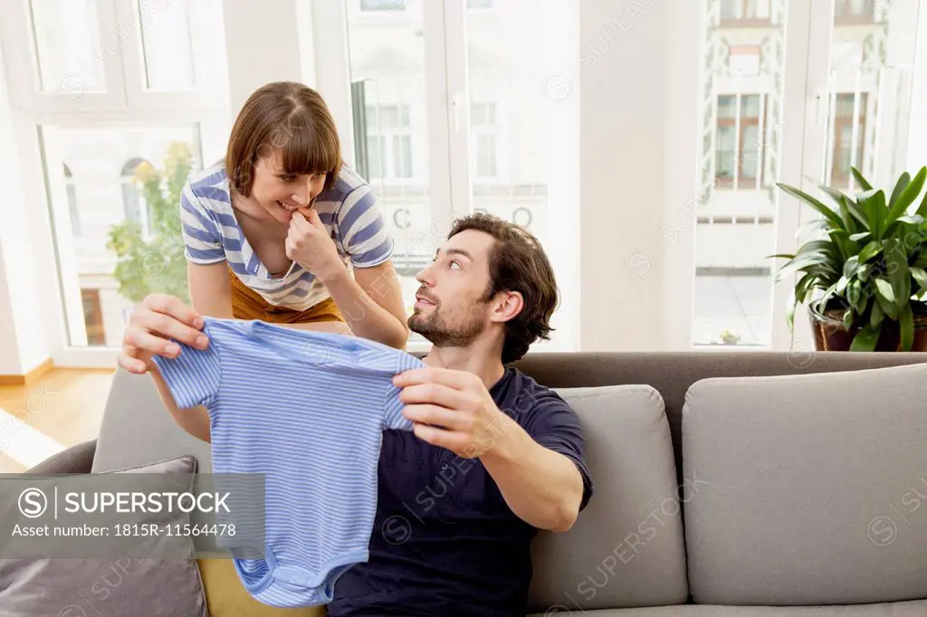 Expectant parents with blue baby shirt