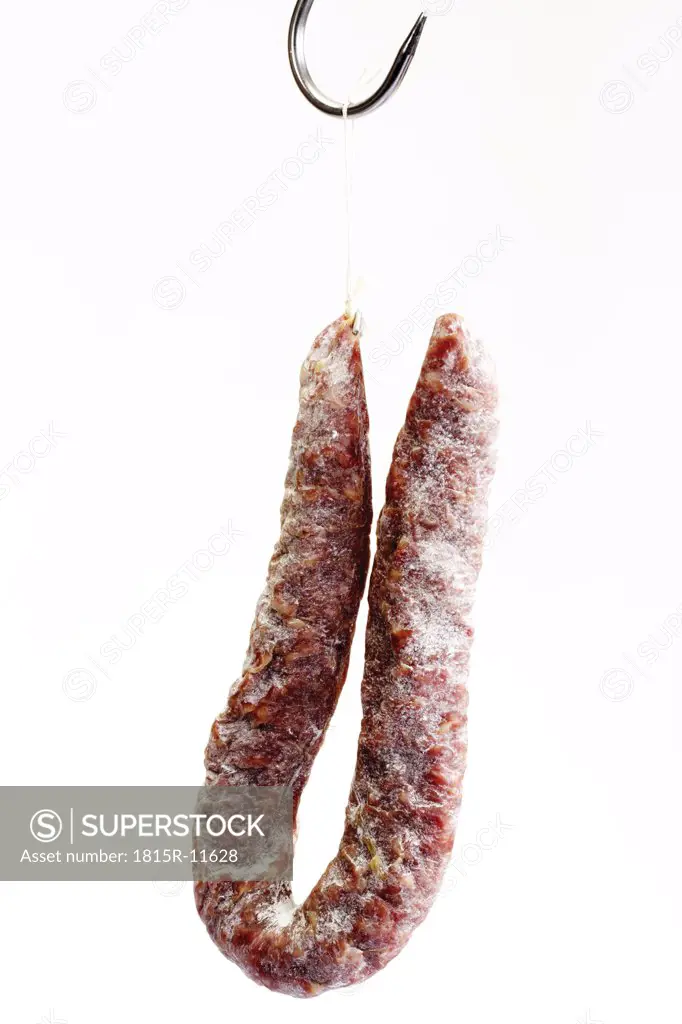 Salami hanging on butcher hook, close-up