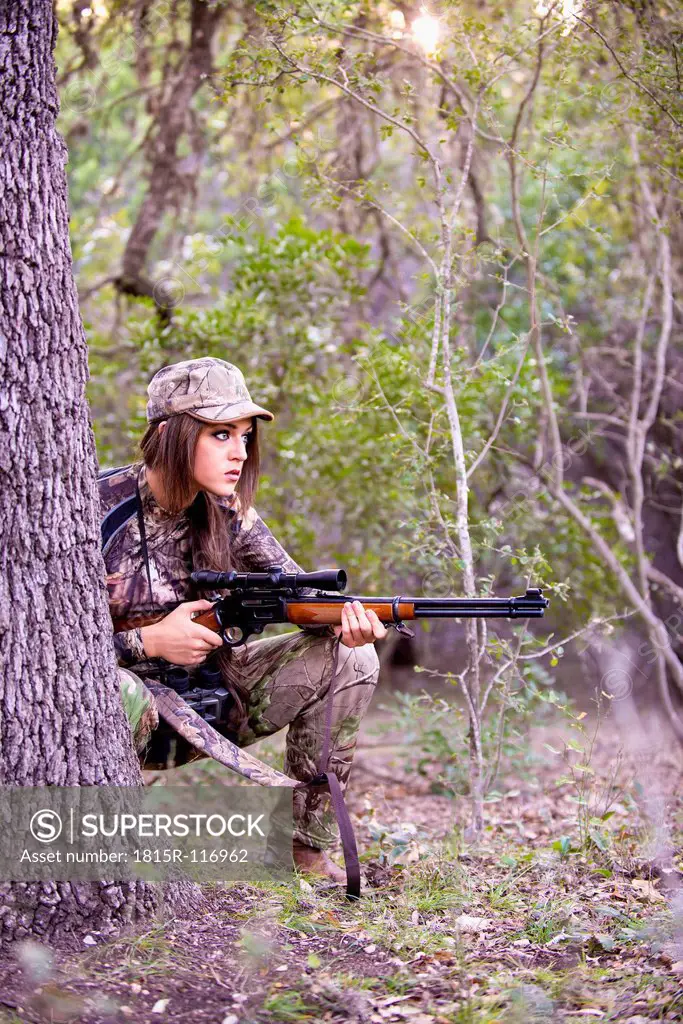 USA, Texas, Young woman with Lever Action Hunting Rifle
