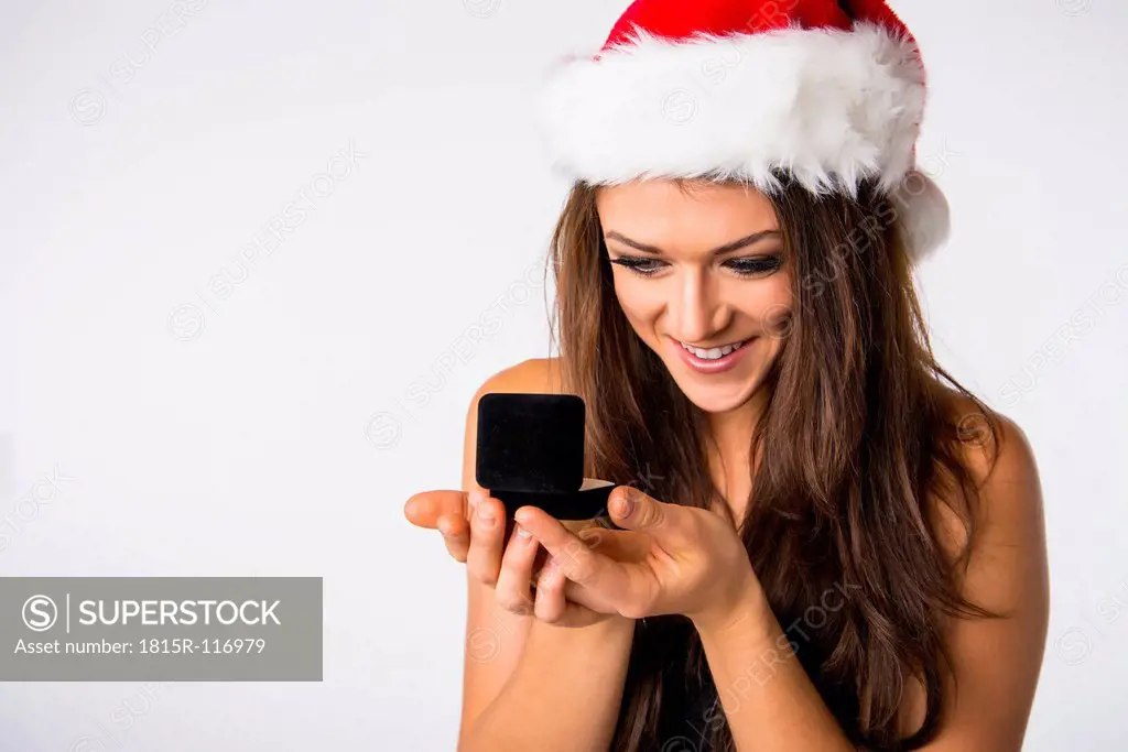 Young woman with Christmas cap, looking at jewellery box
