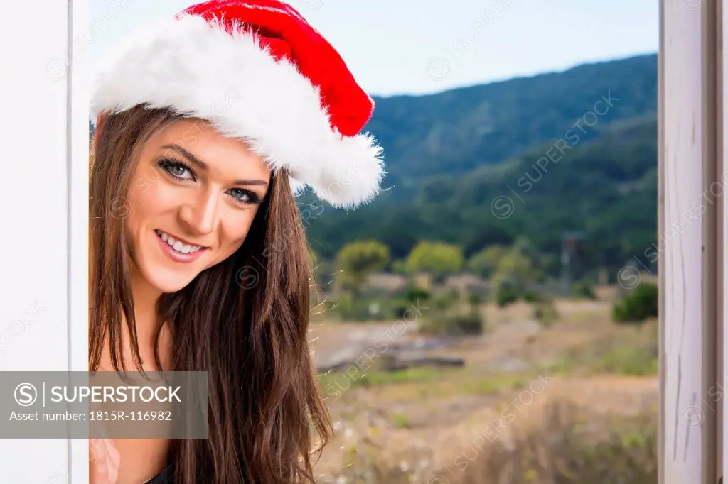 Young woman with Christmas cap, smiling, portrait