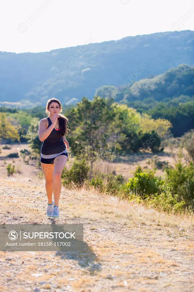 USA, Texas, Young woman jogging