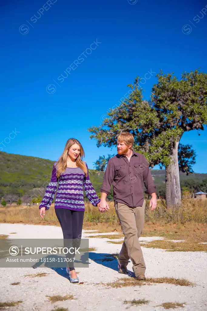 USA, Texas, Man and pregnant woman walking