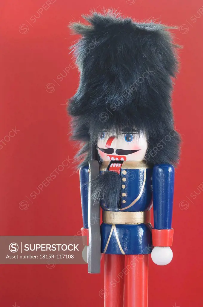 Close up of Nutcracker figurine against red background