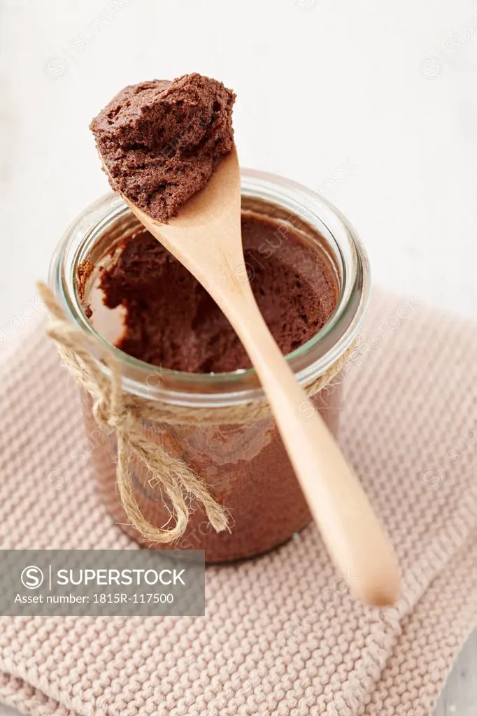 Mousse au Chocolat in jar with wooden spoon