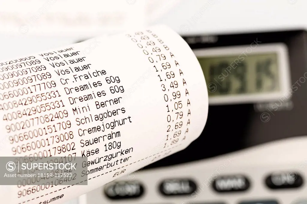 Shopping receipt for groceries with calculator, close up