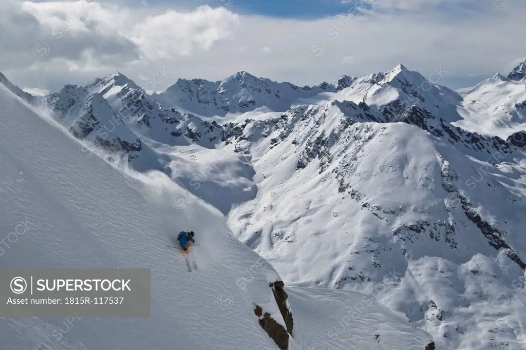 Austria, Tirol, Young man doing freeride skiing
