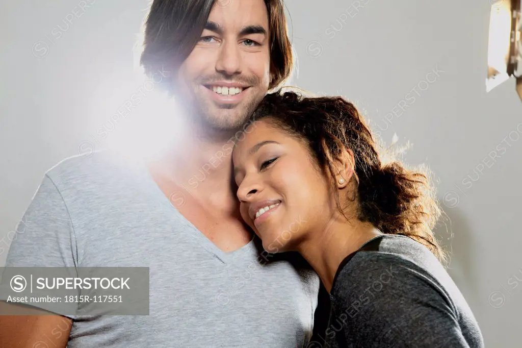 Close up of couple against gray background, smiling