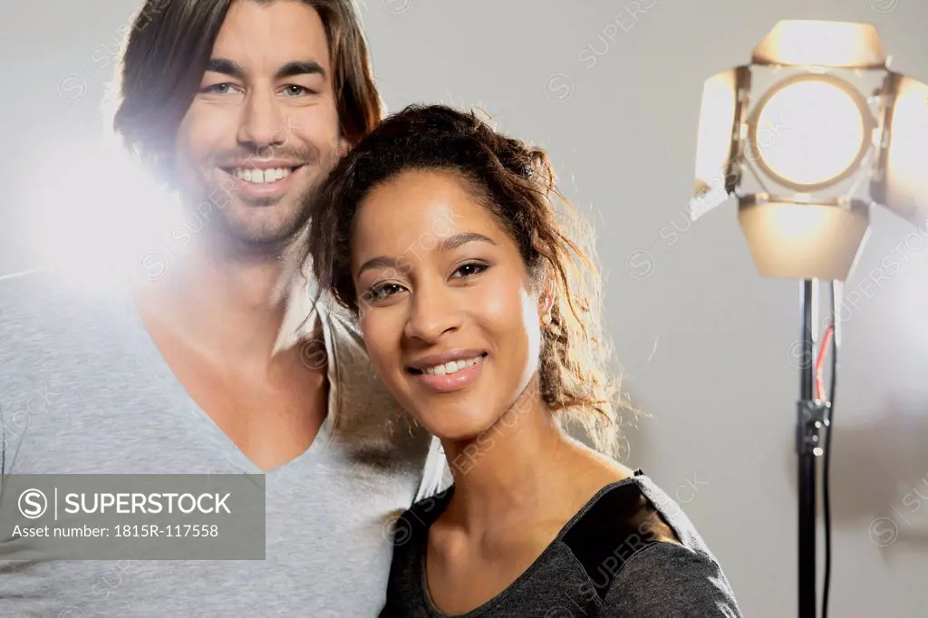 Portrait of couple against gray background, smiling