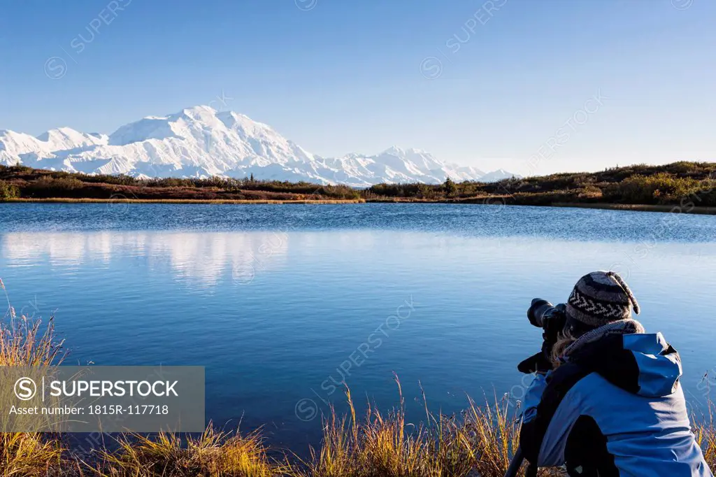 USA, Alaska, Mature woman taking photo of Mount Mckinley at Denali National Park