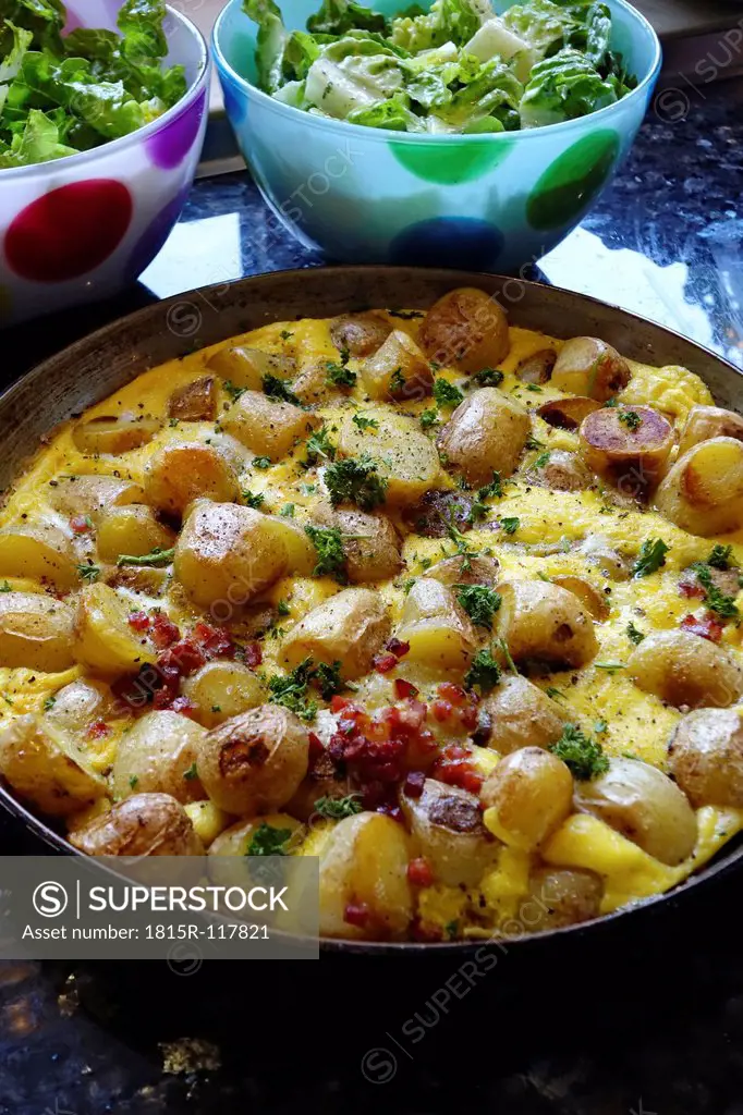 Fried potatoes with ham and eggs, close up