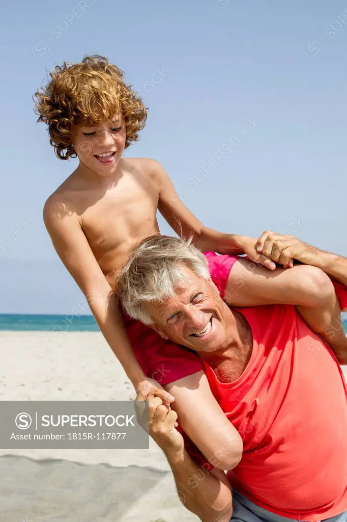 Spain, Grandfather carrying grandson on shoulder
