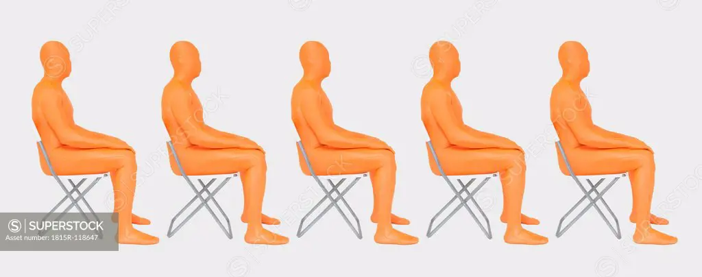 Men in orange zentai sitting on chair, close up