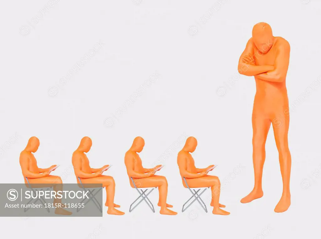Men in orange zentai using digital tablet, close up