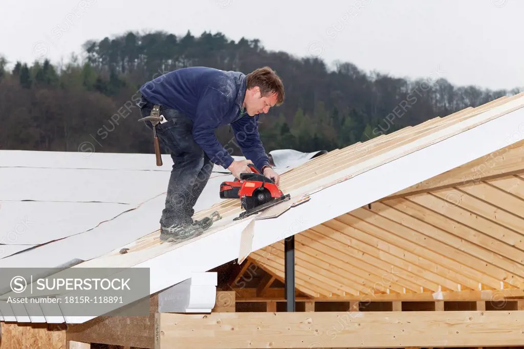 Europe, Germany, Rhineland Palatinate, Worker roofing on house