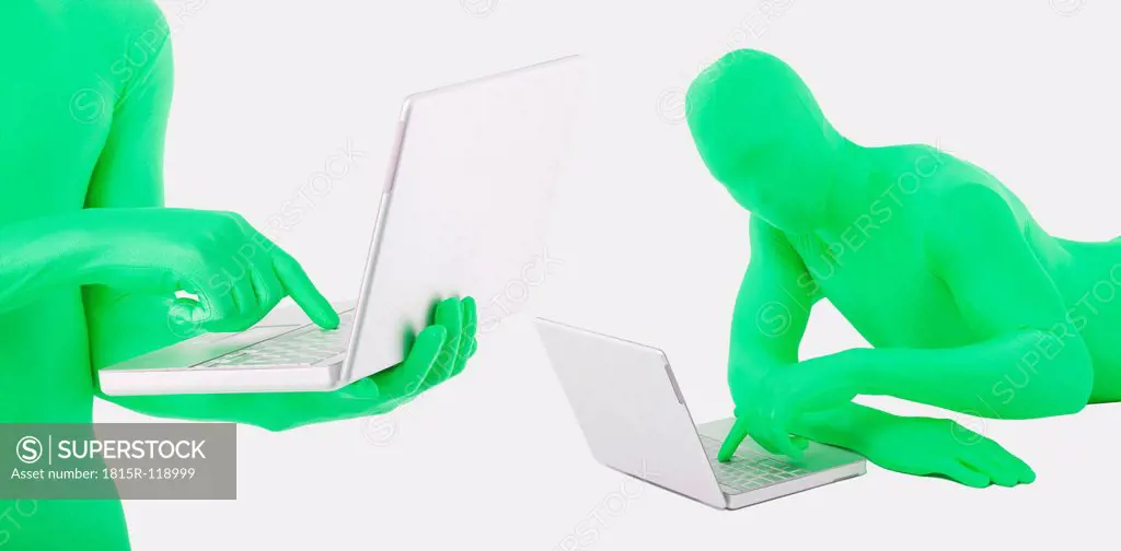 Men in green zentai using laptop