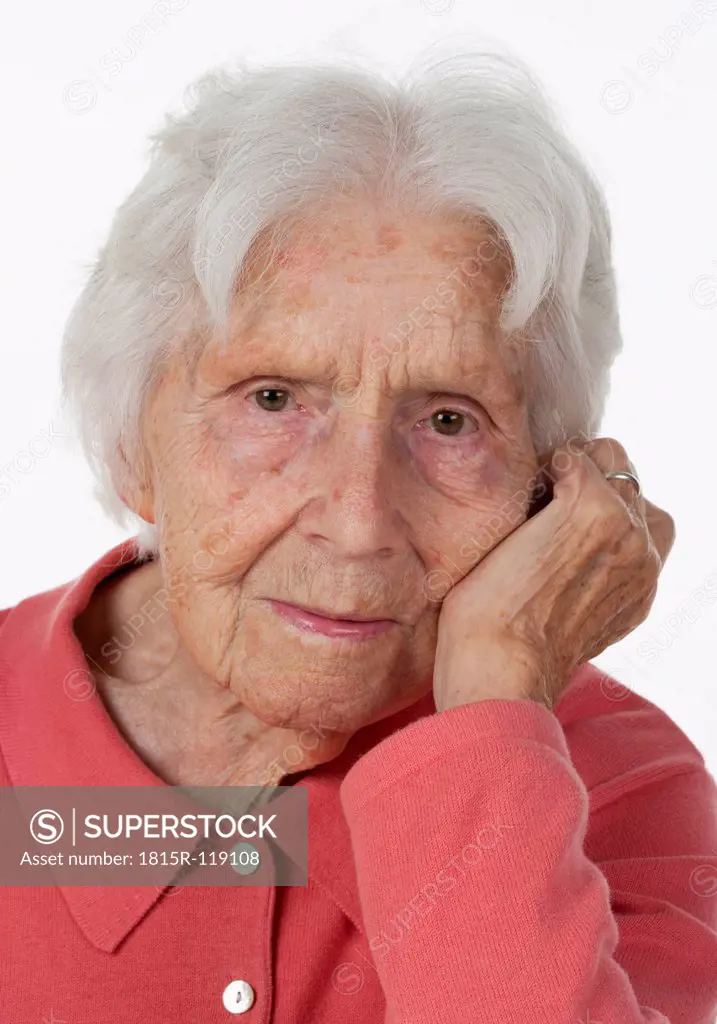 Portrait of senior woman against white background, close up