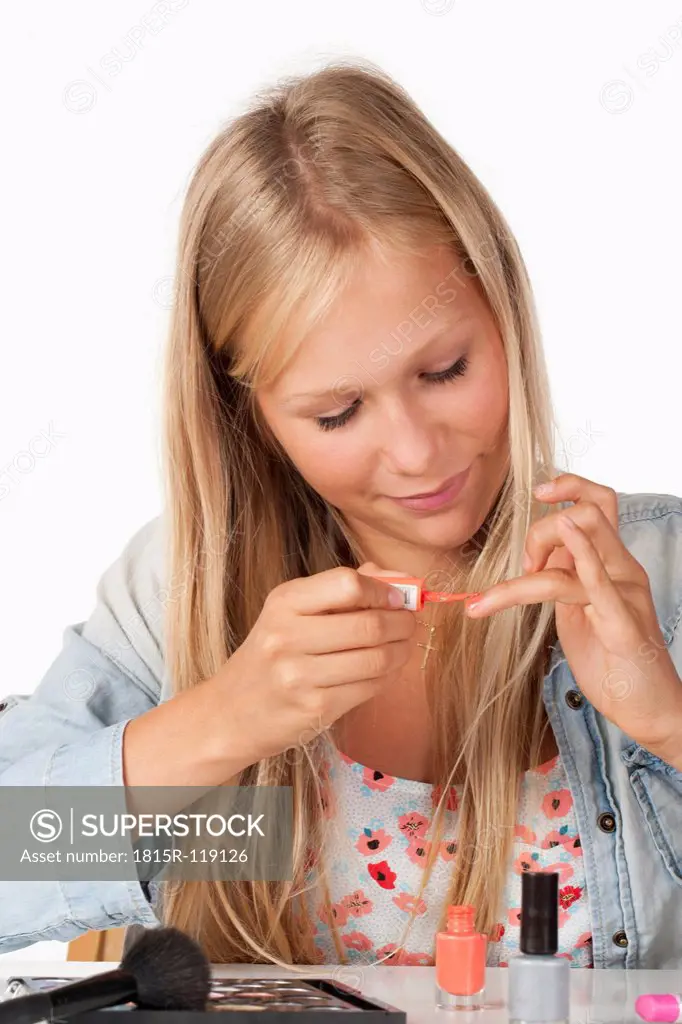 Teenage girl applying nail polish, close up